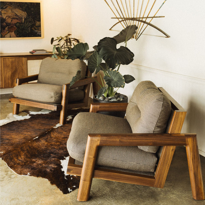 The Earl Home Walnut TAMBU Lounge Chair boasts kvdrat fuse striped fabric upholstery, a sturdy walnut frame, and plush down cushioned seat and backrest gives the ultimate cozy hygge vibe.