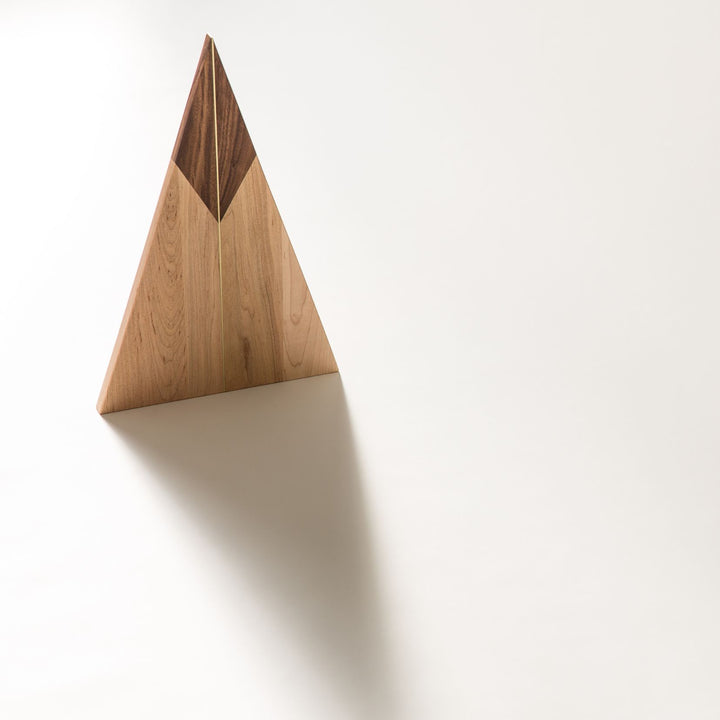 The TRIANGLE Cheese Board by Earl Home is a stylish centerpiece with a triangular design. It is solid walnut and maple featuring a brass spline. Perfect for your cheeseboard or charcuterie spread.