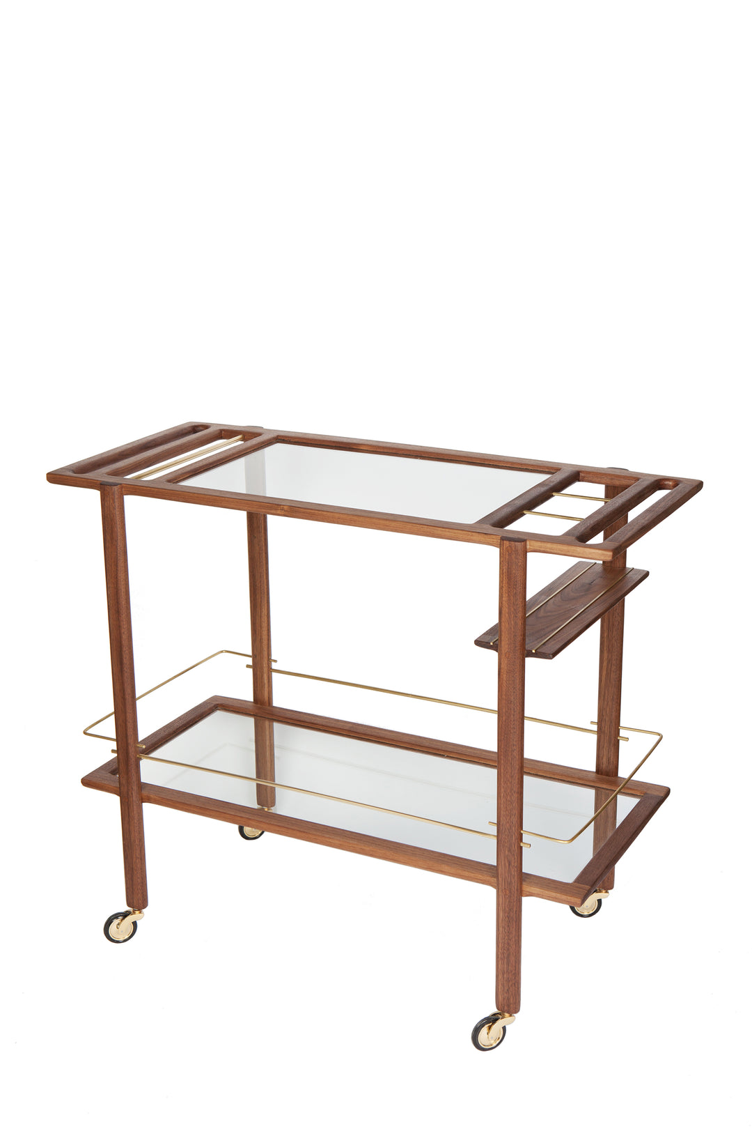 The BAR Cart from Earl Home is a solid wood bar cart on wheels with exquisite hand-cut joinery, featuring two shelves: a robust wood top and an elegant lower shelf made of tempered glass panels.