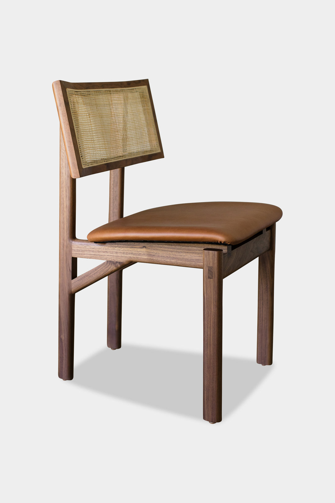 The KUNAI Dining Chair by Earl Home is handcrafted to order, featuring a solid wood frame, brown leather seat, and woven backrest.